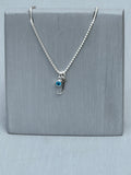 Embrace personalized elegance with our sterling silver initial J necklace, adorned with a dazzling blue zircon crystal—the birthstone for December—suspended delicately on a radiant silver chain. Elevate your style with a touch of sparkle, perfect for celebrating special moments or adding a meaningful accent to your everyday look.