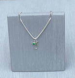 sterling silver initial J necklace, adorned with a dazzling emerald crystal—the birthstone of May. Suspended on a delicate 18inch silver chain, celebrates personal style 