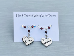 Bride and Groom Wine glass charms. Perfect addition to your wedding top table or as gift to the happy couple!   2 charms set on a silver plated rings with Austrian crystals.  Item will be sent in an organza bag.  Crystal colours can be changed – see next picture.   Please contact me if you require different coloured crystals.