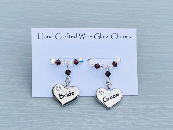 Bride and Groom Wine glass charms. Perfect addition to your wedding top table or as gift to the happy couple!   2 charms set on a silver plated rings with Austrian crystals.  Item will be sent in an organza bag.  Crystal colours can be changed – see next picture.   Please contact me if you require different coloured crystals.
