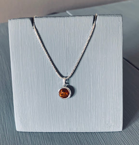 Set on a 925 Sterling Silver 18" Chain is a necklace set with a Topaz Swarovski Crystal in a 925 sterling silver casement setting